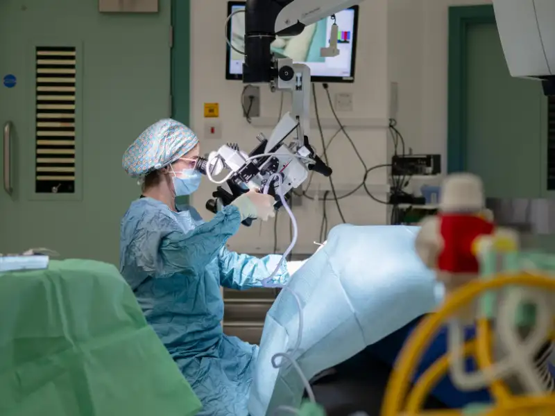 Yasmin Abbas in surgery with a microscope